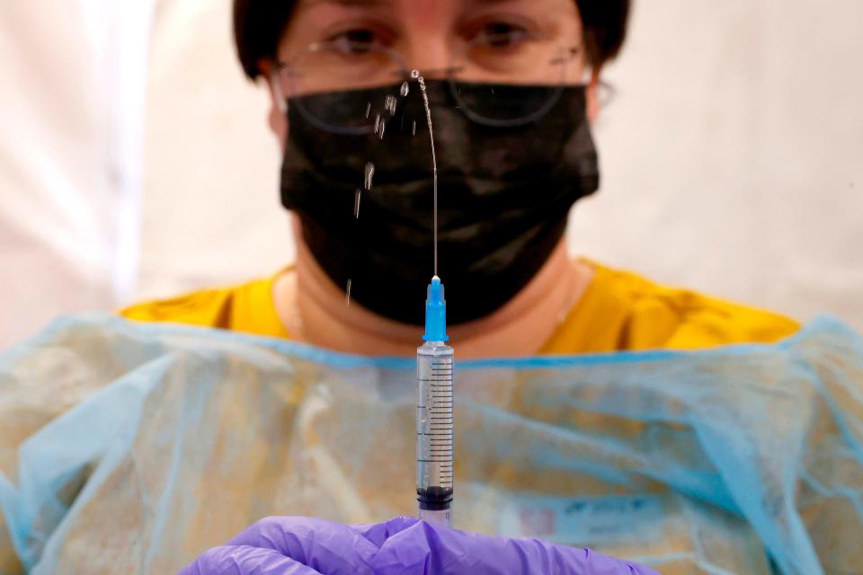 A health care worker prepares a dose of the Pfizer-BioNtech COVID-19 vaccine at a large vaccination center open by the Tel Aviv-Yafo Municipality and Tel Aviv Sourasky Medical Center on Dec. 31, 2020, in the Israeli coastal city.