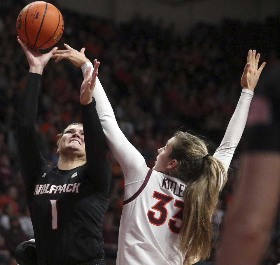 North Carolina State's River Baldwin, left, shoots while defended by Virginia Tech's Elizabeth Kitley (33) during the first half of an NCAA college basketball game Sunday, Feb. 19, 2023, in Blacksburg, Va. (Matt Gentry/The Roanoke Times via AP)
