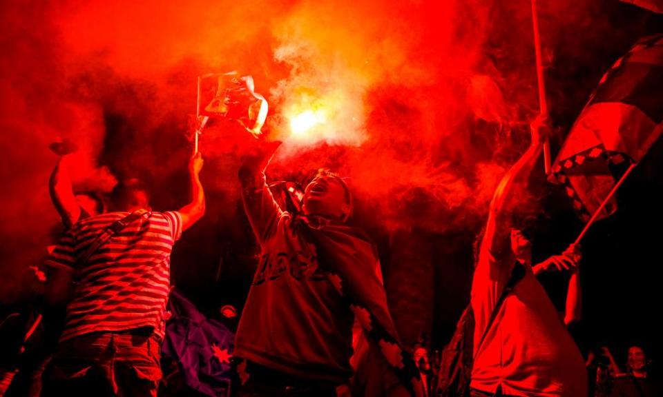 A demonstrator supporting the reform of the Chilean constitution lights a flare in Plaza Italia square in Santiago.