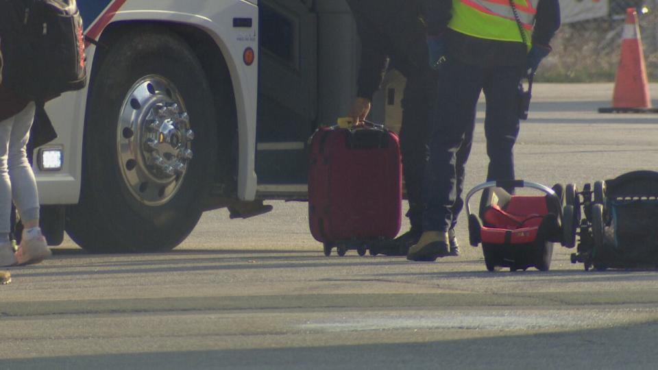 Luggage is loaded onto a bus after refugees arrived from Afghanistan via plane.