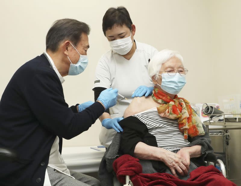 An elderly woman receives a coronavirus disease (COVID-19) vaccine shots at a nursery home in Tsu, Japan