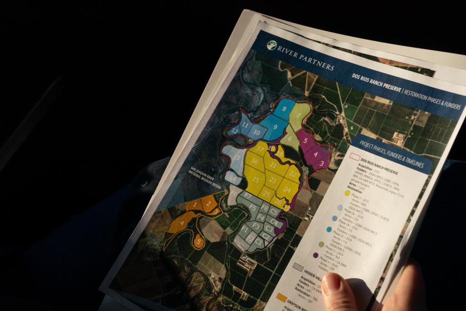 A paper map shows floodplain restoration areas.