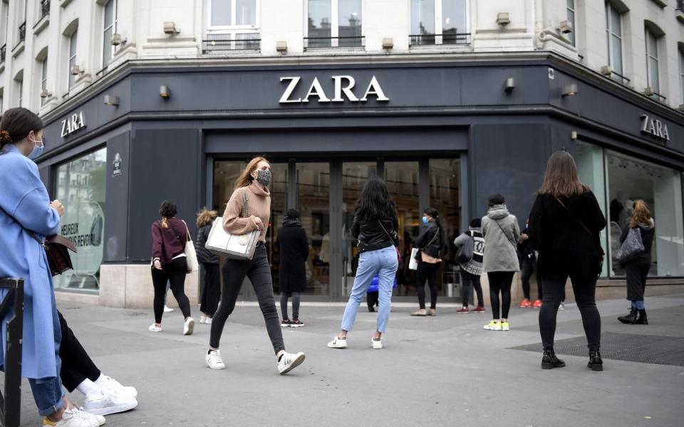 Shoppers form a not-so-orderly queue outside a Zara store reopening in Paris on 11th May 2020