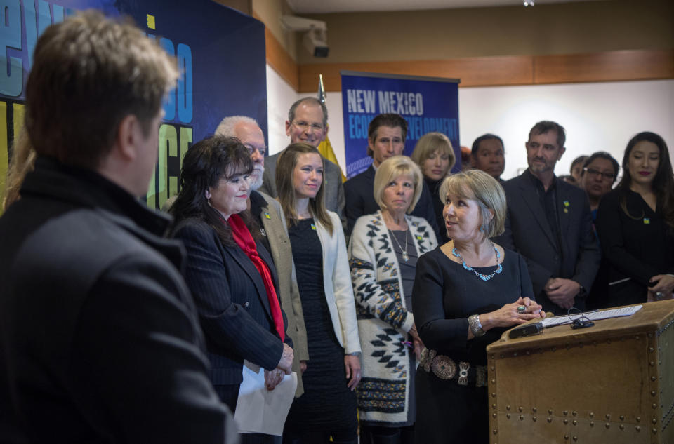 FILE - In this Feb. 1, 2019, file photo, New Mexico Gov. Michelle Lujan Grisham, center, holds a news conference about film incentives with Sen. Nancy Rodriguez, D-Santa Fe, second from left, and others in Santa Fe, N.M. New Mexico's film industry appears to be on the brink of a boom thanks to abortion law controversies in other states and expanded incentives. The Albuquerque Journal reports a recent rise in film productions in the state as Hollywood targets Georgia and Louisiana over recently passed restrictive abortion laws. (Eddie Moore/The Albuquerque Journal via AP, File)