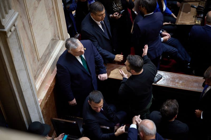 Ukraine's President Zelenskiy speaks with Hungary's Prime Minister Orban during the inauguration of newly-elected President Javier Milei in Buenos Aires