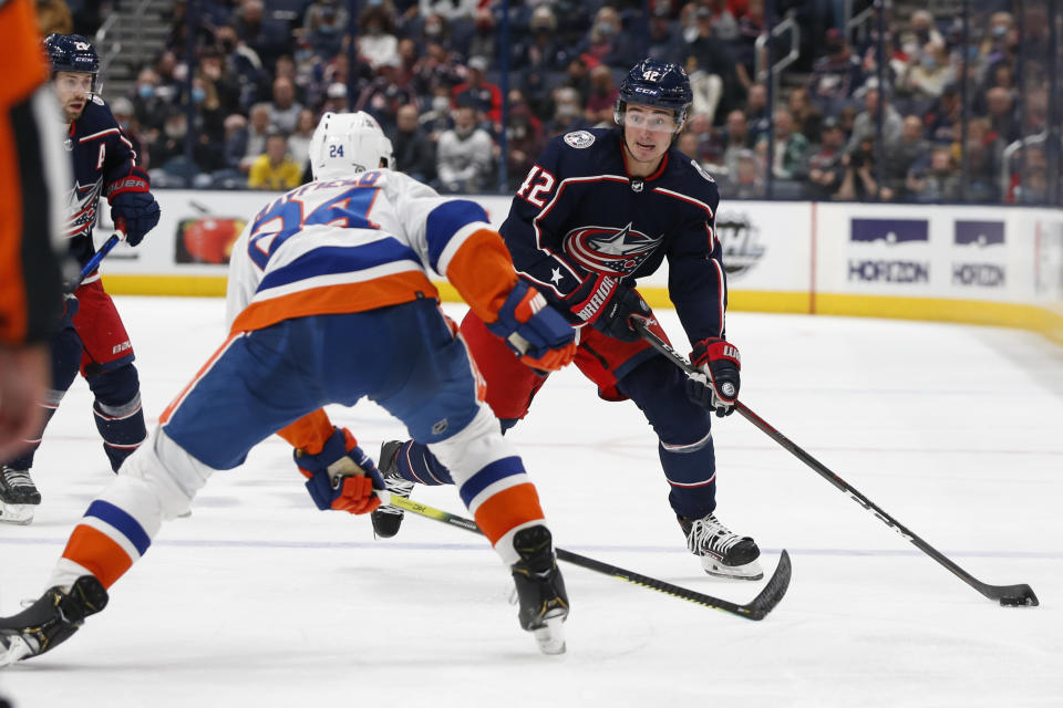 Columbus Blue Jackets' Alexandre Texier, right, looks for an open pass as New York Islanders' Scott Mayfield defends during the second period of an NHL hockey game Thursday, Oct. 21, 2021, in Columbus, Ohio. (AP Photo/Jay LaPrete)