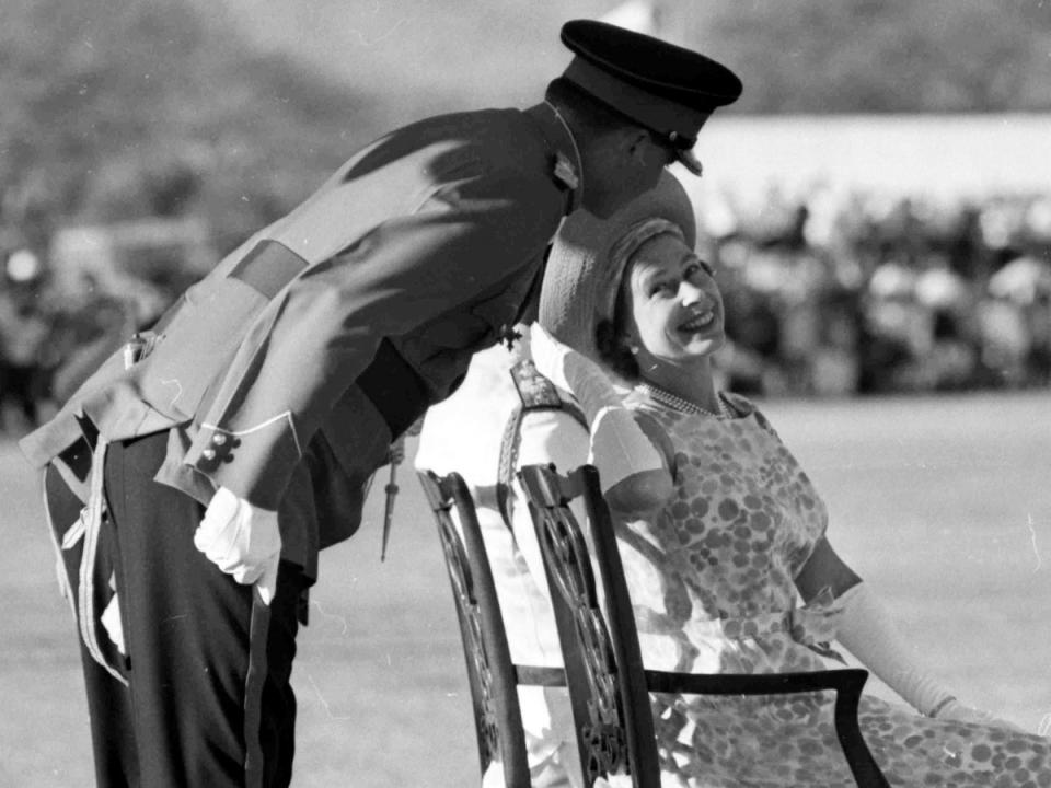 Queen Elizabeth II as she turns to smile and talk to an unidentified officer, during the Trooping of the Colour by the First Battalion of the Jamaica Regiment at Up-Park Camp, Kingston, Jamaica, 1966 (Getty)