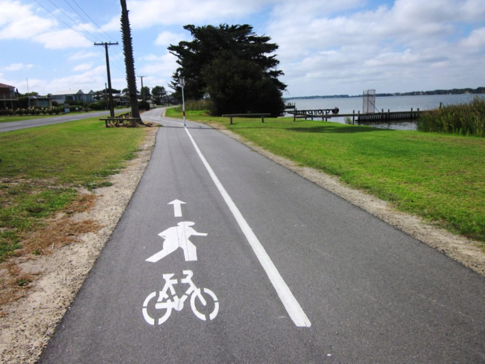 Pictured is a tarred path shared by pedestrians and cyclists.