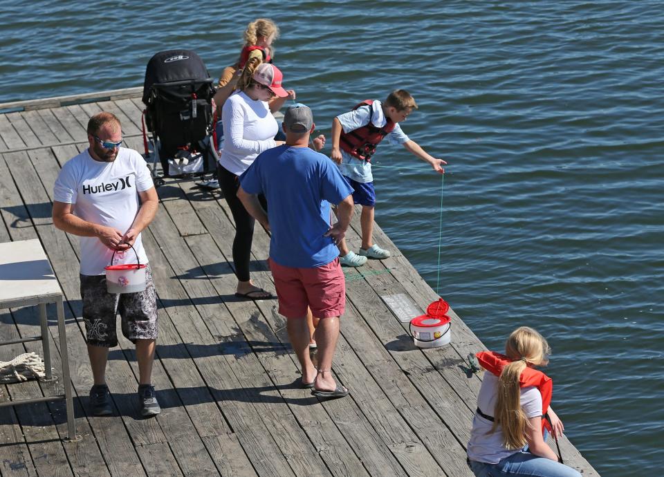 Families have some fun catching crabs and releasing them on the docks at Wells Harbor.