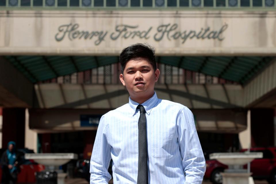 Jerick Tabudlo, in front of Henry Ford Hospital in Detroit, on Thursday, April 27, 2023. Tabudlo is an operating room nurse from the Philippines and landed in Detroit on Tuesday, April 25 to start a new job at the hospital. With a big nurse shortage going on, Henry Ford Health looked toward the Philippines and Tabudlo is the first of as many as up to 600 are expected to come in the next year to fill various open nursing positions throughout the health system.