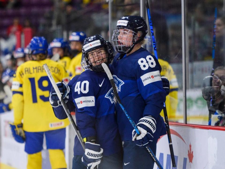 Finland defender Ronja Savolainen (88) and forward Noora Tulus (40) celebrate after a goal at the 2023 women's world championship in Brampton, Ont., last year. Both have declared for the 2024 PWHL draft. (Christopher Katsarov/The Canadian Press - image credit)