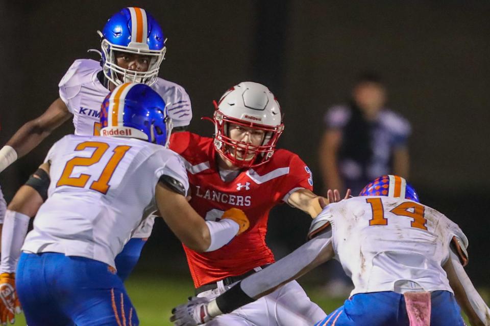 East Union quarterback Luke Weaver is surrounded by a group of Kimball defenders during a varsity football in Manteca.