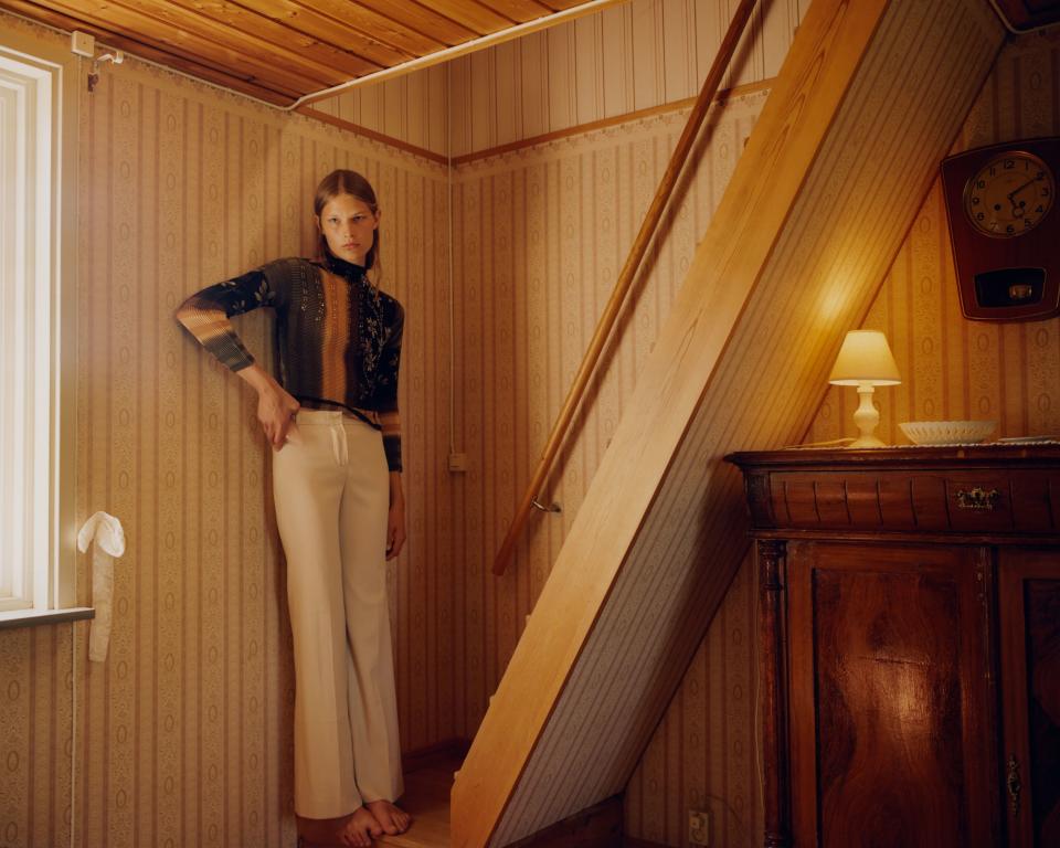 In the stair leading up to the bedroom in the cabin we rented. Adela wears a vintage top and vintage Chloé trousers.