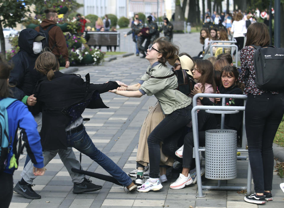 A plainclothed policeman detains a student during a protest in Minsk, Belarus, Tuesday, Sept. 1, 2020. Several hundred students on Tuesday gathered in Minsk and marched through the city center, demanding the resignation of the country's authoritarian leader after an election the opposition denounced as rigged. Many have been detained as police moved to break up the crowds. (Tut.By via AP)