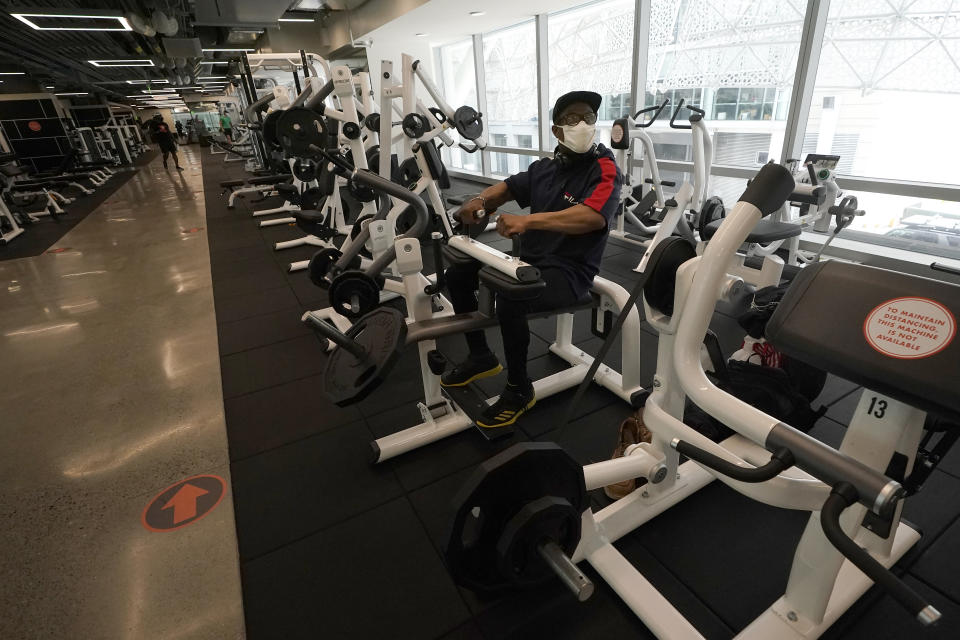 FILE - In this Tuesday, Sept. 15, 2020 file photo Wesley Thomas works out at Fitness SF Transbay during the coronavirus outbreak in San Francisco. A steady drop in coronavirus cases across California cleared the way Tuesday, Sept. 22, 2020, for the wider reopening of businesses in nine counties, including much of the Bay Area, the state said. (AP Photo/Jeff Chiu,File)