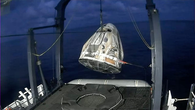 The Inspiration4 Crew Dragon capsule is hauled onto the deck of the SpaceX recovery ship Go Searcher after splashdown in the Atlantic Ocean near Cape Canaveral.  / Credit: SpaceX