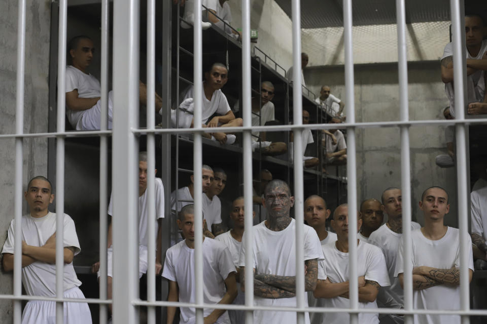 Inmates attend a class on social behavior from inside their shared cell during a press tour of the Terrorism Confinement Center, a mega-prison in Tecololuca, El Salvador, Thursday, Oct. 12, 2023. (AP Photo/Salvador Melendez)