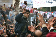 FILE – In this Dec. 30, 2004 file photo, Zakaria Zubeidi, then leader in the Al Aqsa Martyrs Brigade in the West Bank, is carried by supporters during a presidential elections campaign rally in support of Mahmoud Abbas, in the West Bank town of Jenin. In May, as the Gaza war raged and tensions surged across the Middle East, Instagram briefly banned the hashtag #AlAqsa, a reference to the Al-Aqsa Mosque in Jerusalem's Old City, a flash point in the conflict. Facebook, which owns Instagram, later apologized, explaining its algorithms had mistaken the third-holiest site in Islam for the militant group Al-Aqsa Martyrs Brigade, an armed offshoot of the secular Fatah party. (AP Photo/Nasser Nasser, File)