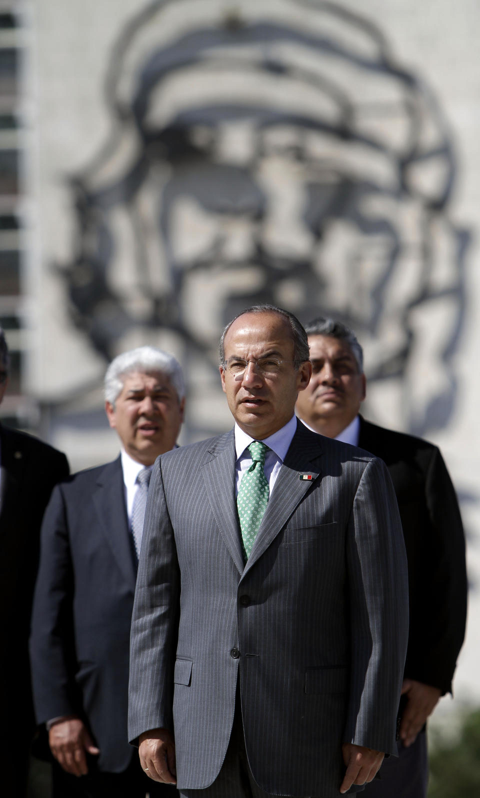 Mexico's President Felipe Calderon, front, attends a wreath-laying ceremony at the Jose Marti monument in Havana, Cuba, Wednesday, April 11, 2012. Calderon is on a two-day official visit to Cuba. In background, an image of Cuba's revolutionary hero Ernesto "Che" Guevara. (AP Photo/Franklin Reyes)