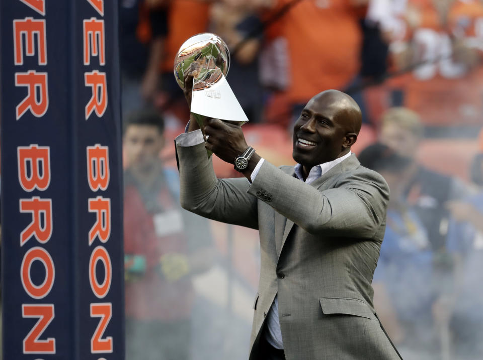 FILE - In this Sept. 8, 2016, file photo, Super Bowl XXXII MVP Terrell Davis carries the Lombardi Trophy onto the field prior to an NFL football game between the Denver Broncos and the Carolina Panthers, in Denver. The coronavirus pandemic scuttled most college pro days, wiped out all rookie minicamps and obliterated the NFL's traditional offseason, making it became almost impossible for long shots to make their mark and, consequently, the 53-man roster. Among them: Hall of Famer Terrell Davis. Davis ended the frustrations of a long-suffering franchise, city and larger-than-life quarterback who could never win the big game before he came along. (AP Photo/Jack Dempsey, File)