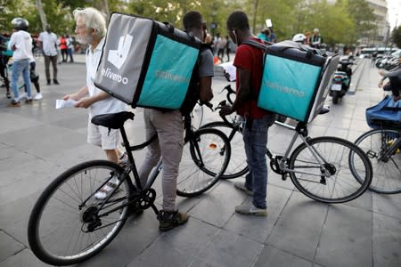 Bikers of food courier service Deliveroo demonstrate as they called on clients to boycott the brand in Paris