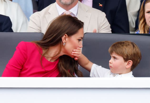 Louis covers his mother's mouth with his hand as they attend the Platinum Pageant on The Mall on June 5, 2022, in London.