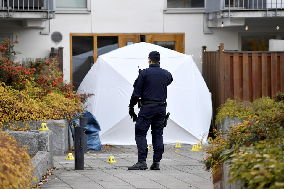 Forensic police stand at the scene where Swedish rapper Einar was shot to death, in Hammarby Sjostad district in Stockholm, Friday, Oct. 22, 2021. An award-winning 19-year-old Swedish rapper was shot to death in southern Stockholm in an incident that media reports on Friday suggested could be gang-related. The rapper Einar was struck by several bullets in the Hammarby suburb south of central Stockholm and died on the spot late Thursday, police spokesman Ola Osterling told the Swedish news agency TT. (Henrik Montgomery/TT via AP)