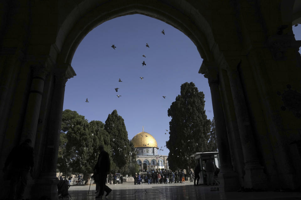 Birds fly over the Al-Aqsa Mosque compound in the Old City of Jerusalem following an Israeli police raid overnight during the Muslim holy month of Ramadan, Wednesday, April 5, 2023. Palestinian media reported police attacked Palestinian worshippers, raising fears of wider tension as Islamic and Jewish holidays overlap.(AP Photo/Mahmoud Illean)