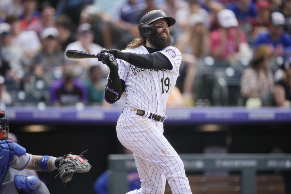 Colorado Rockies' Charlie Blackmon follows the flight of his two-run home run off New York Mets relief pitcher Stephen Nogosek in the fifth inning of a baseball game Sunday, May 28, 2023, in Denver. (AP Photo/David Zalubowski)