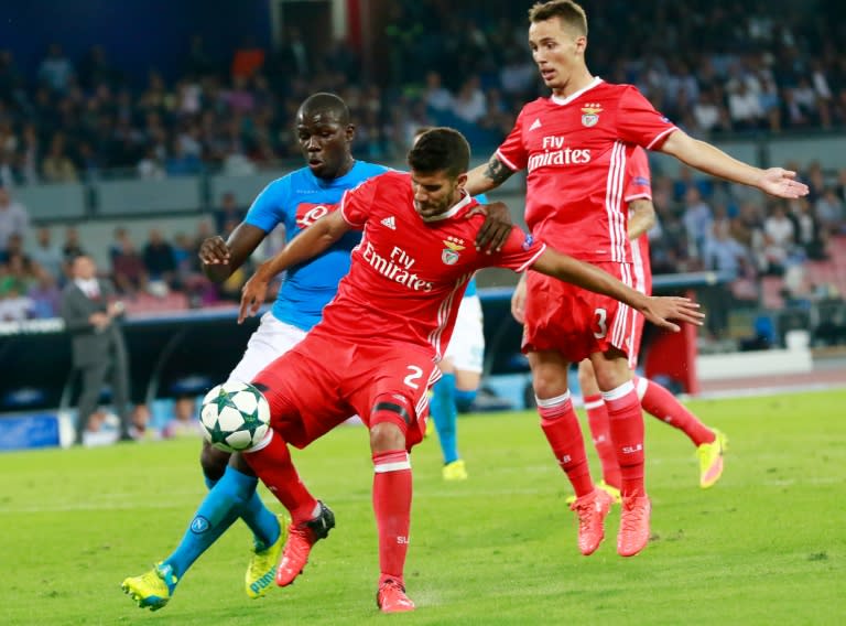 Benfica's defender Lisandro Lopez (C) and Benfica's defender Alejandro Grimaldo fight for the ball with Napoli's defender Kalidou Koulibaly (L) during the UEFA Champions League football match SSC Napoli vs SL Benfica