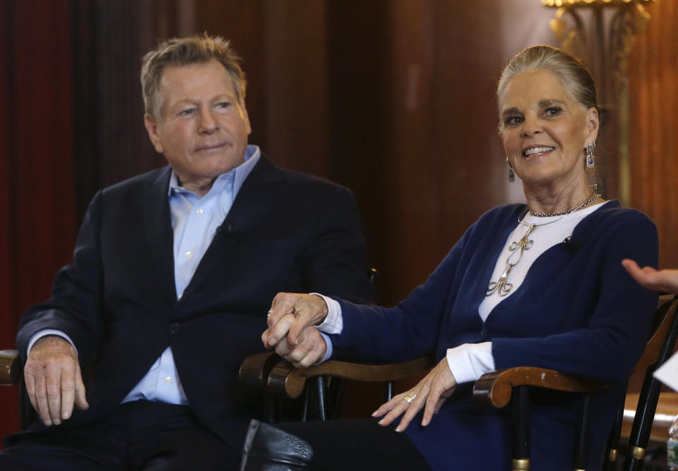 FILE - Actors Ryan O'Neal, left, and Ali MacGraw hold hands as they are introduced for a talk with students on the campus of Harvard University in Cambridge, Mass., Monday Feb. 1, 2016, more than 45 years after the release of their 1970 classic "Love Story." O’Neal, who was nominated for an Oscar for the tear-jerker “Love Story” and played opposite his precocious daughter Tatum in “Paper Moon,” has died. O’Neal's son Patrick said on Instagram that his father died Friday, Dec. 8, 2023. (AP Photo/Elise Amendola, File)