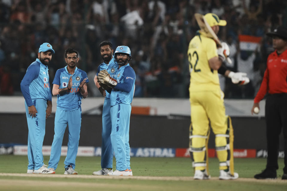 India's captain Rohit Sharma, left, and teammates celebrate after Australia's Glenn Maxwell, second right, is run-out during the third T20 cricket match between India and Australia, in Hyderabad, India, Sunday, Sept. 25, 2022. (AP Photo/Mahesh Kumar A)