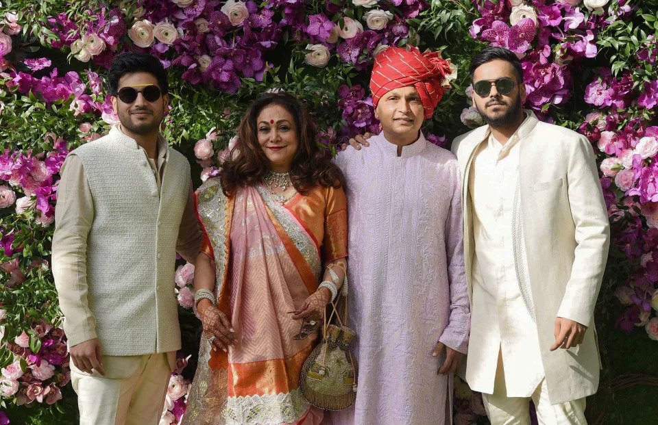 Indian businessman Anil Ambani (2nd R) poses for photographs along with his wife and former Bollywood actress Tina Ambani (2nd L) and their sons, Anshul Ambani (R) and Anmol Ambani (L), as they arrive to attend the wedding ceremony of Akash Ambani, son of Indian Businessman Mukesh Ambani, in Mumbai on March 9, 2019. (Photo by SUJIT JAISWAL / AFP) (Photo by SUJIT JAISWAL/AFP via Getty Images)