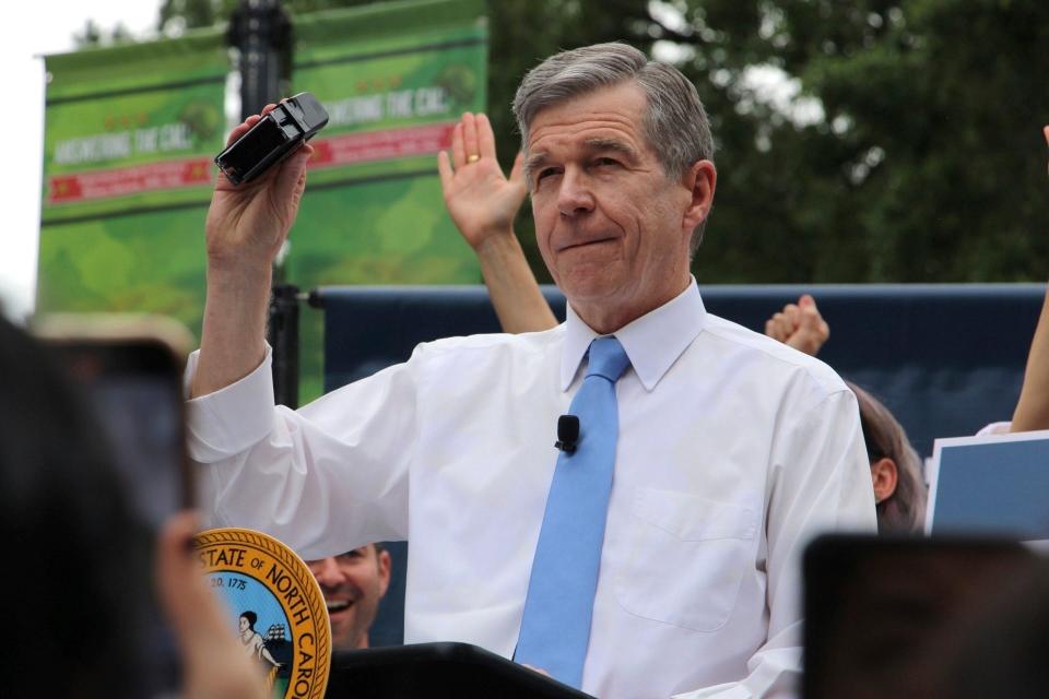 North Carolina Democratic Gov. Roy Cooper affixes his veto stamp to a bill banning nearly all abortions after 12 weeks of pregnancy at a public rally Saturday, May 13, 2023, in Raleigh, North Carolina.