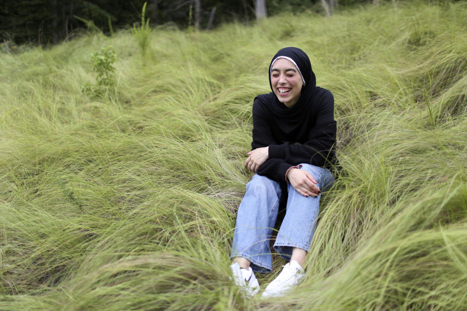 Amirah Ahmed, 17, outside of her home in Fredericksburg, Va., on Sunday, Aug. 15, 2021. Born after the 9/11 attacks, Ahmed feels she was thrust into a struggle not of her making. After 9/11, many young American Muslims have found ways to fight back against bias, to organize and craft nuanced personal narratives about their identities. (AP Photo/Jessie Wardarski)