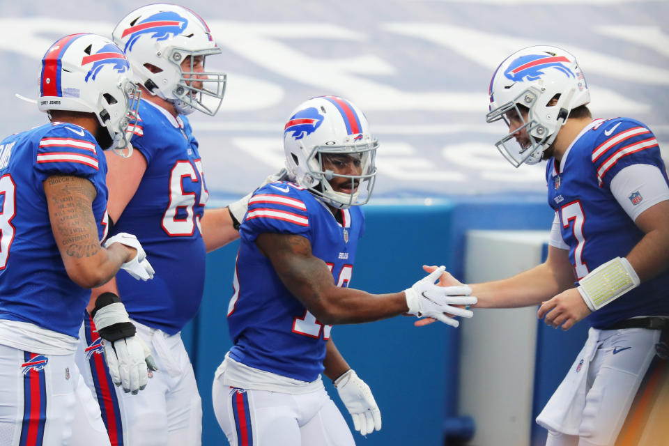 Ike Boettger, second from left, Isaiah McKenzie, center, and Josh Allen celebrate a second-quarter score. (Photo by Timothy T Ludwig/Getty Images)