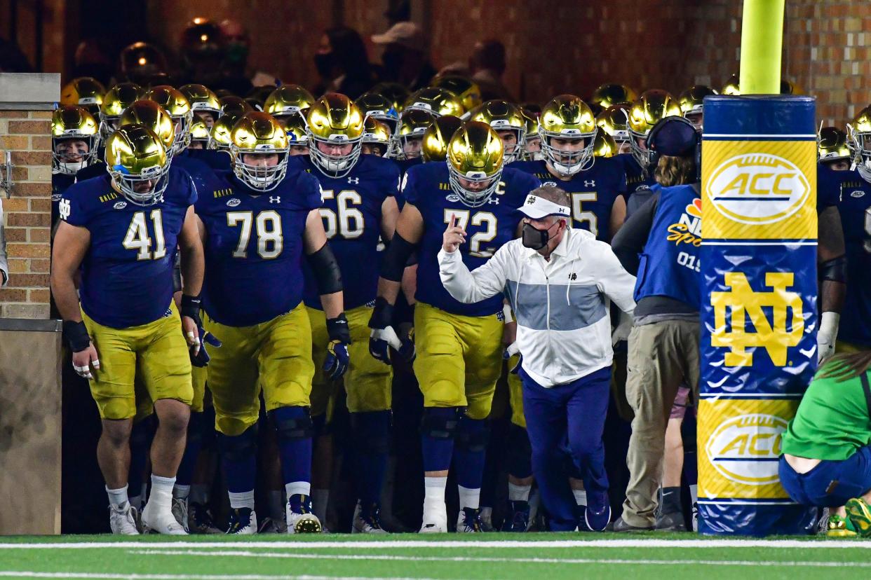 Notre Dame Fighting Irish head coach Brian Kelly leads his team out of the tunnel before a game.