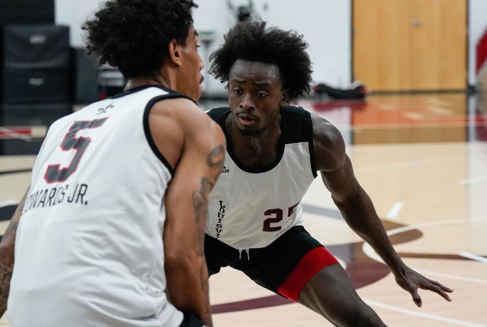 Aboubacar Traore guards Terrence Edwards Jr. during practice before the Cards headed to the Bahamas.