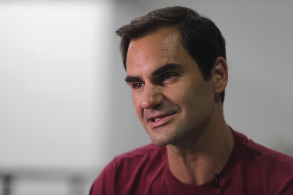 FILE - In this Sunday, Dec. 15, 2019, file photo, Roger Federer talks to an Associated Press reporter in Dubai, United Arab Emirates. Federer figures Rafael Nadal and Novak Djokovic both will surpass his men's record for Grand Slam titles. Federer also says he's OK with that because he had his moment on top. (AP Photo/Kamran Jebreili, File)