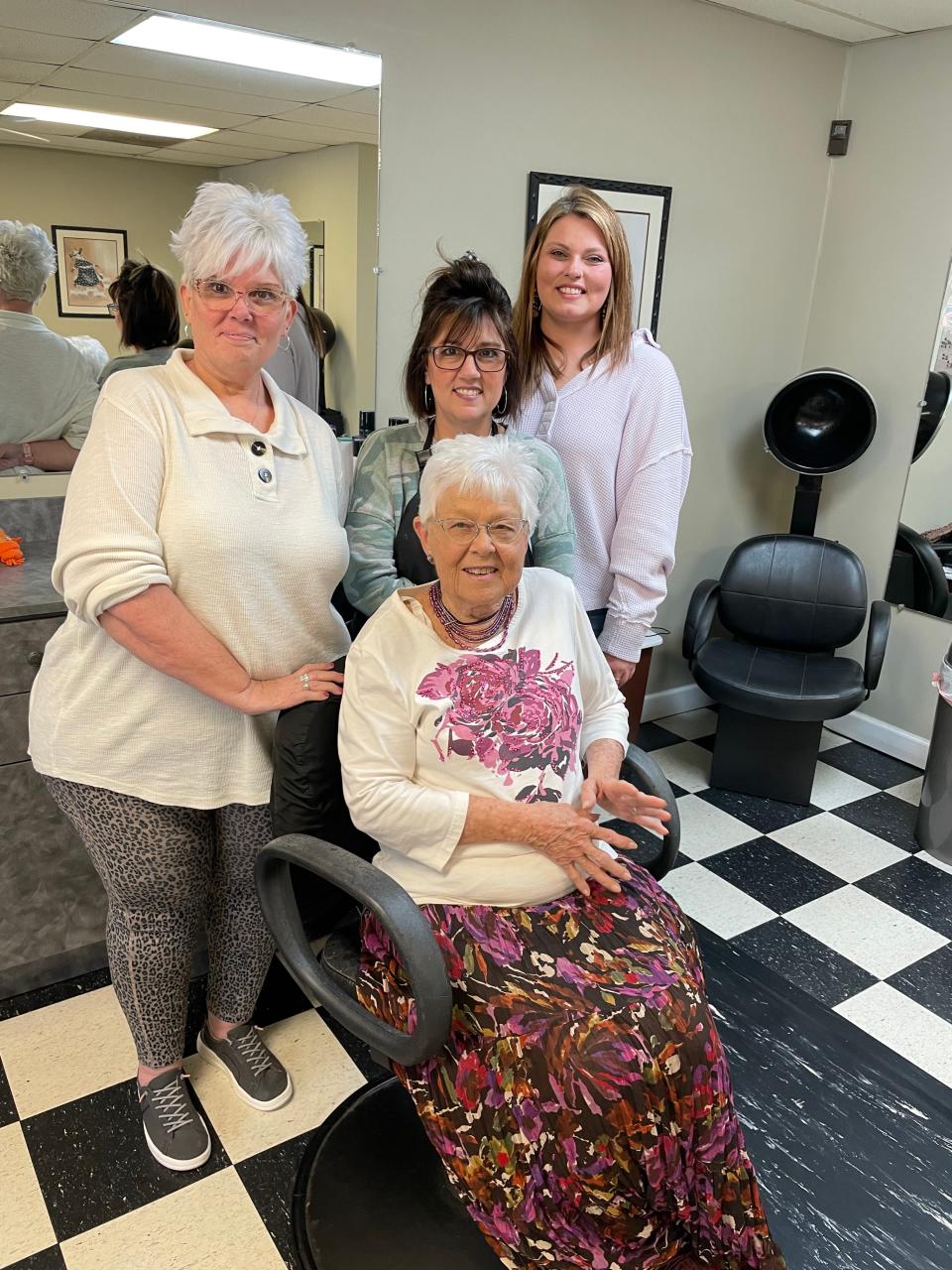 Colleagues (from left) Robin Martin, Melissa Johnson and Krista Maples celebrate Martha Neskaug on her last day in 2024 at Simply Hair & Nails in Knoxville, Tennessee.