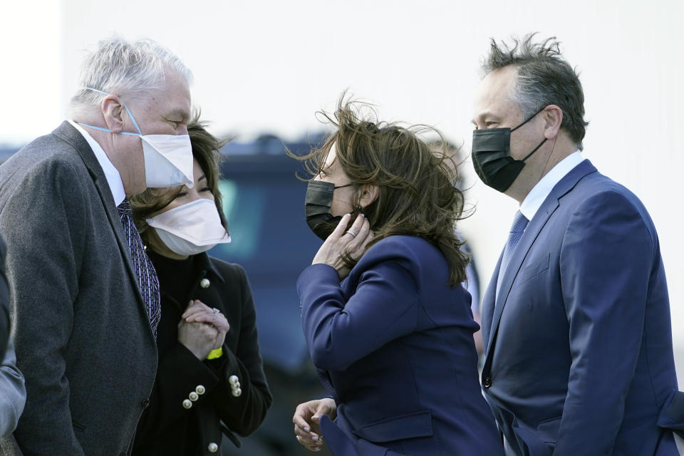 Vice President Kamala Harris and her husband, Doug Emhoff, are greeted by Nevada Gov. Steve Sisolak and his wife Kathy, as they arrive in Las Vegas, Monday, March 15, 2021. President Joe Biden, Vice President Kamala Harris and their spouses are opening an ambitious, cross-country tour to highlight the $1.9 trillion coronavirus relief plan and its benefits. (AP Photo/Jacquelyn Martin)