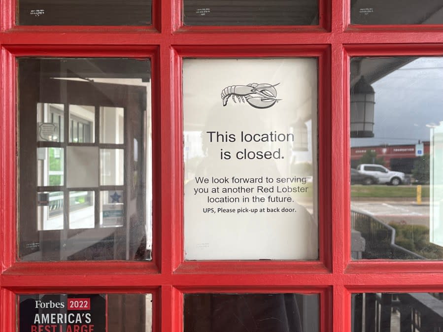 <em>Longview Red Lobster door with sign explaining the store is closed.</em>