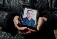 The Wider Image: Japan's tsunami survivors call lost loves on the phone of the wind