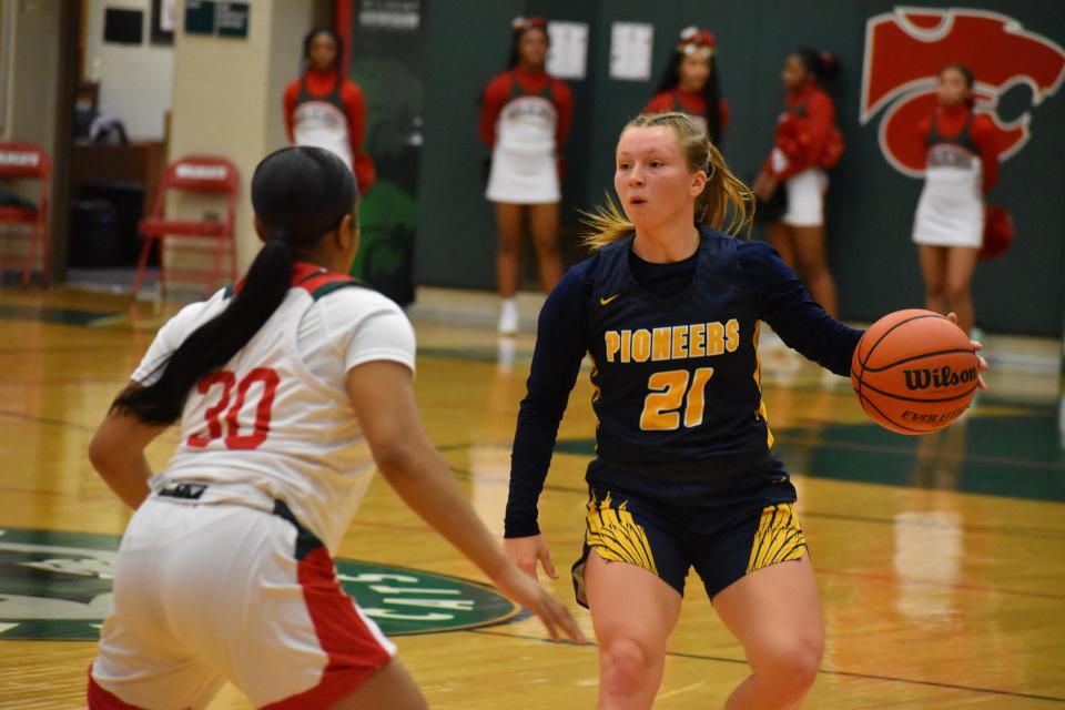 Mooresville senior Madelynn Denny (21) sets up the Pioneers' offense as Lawrence North's Makyla Tucker (30) defends during their game on Nov. 11, 2021.