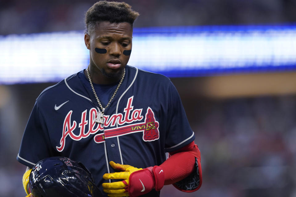 Atlanta Braves' Ronald Acuna Jr. walks off the field after grounding out and stranding two runners during the eighth inning of the team's baseball game against the Texas Rangers in Arlington, Texas, Saturday, April 30, 2022. The Rangers won 3-1. (AP Photo/LM Otero)