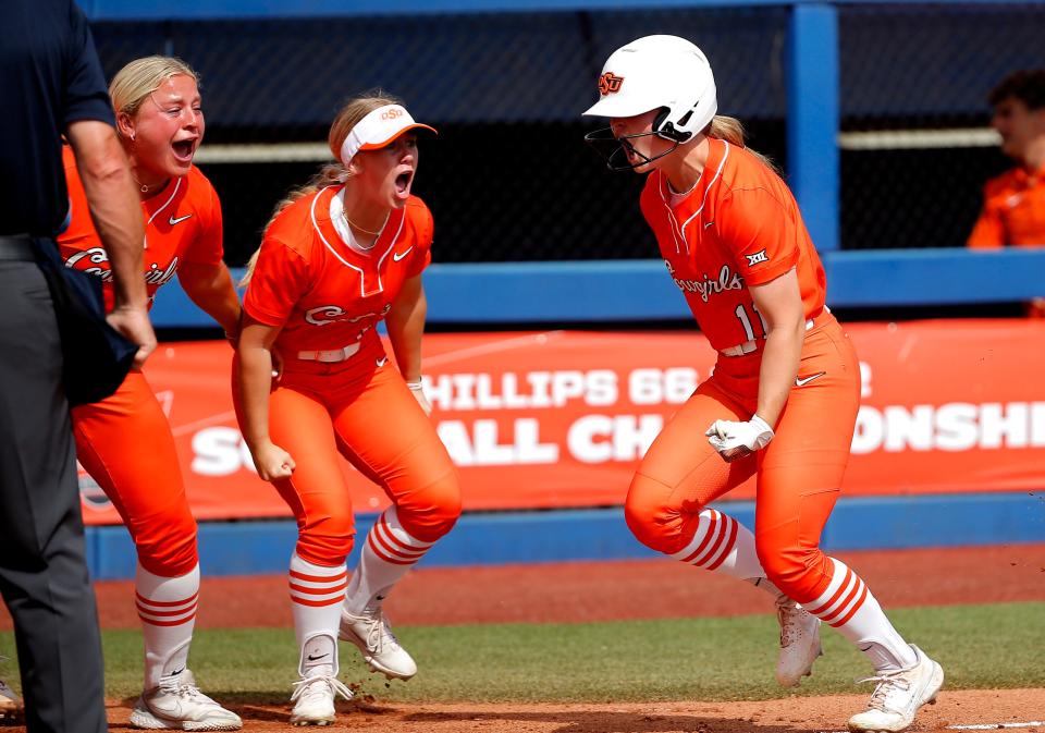 Oklahoma State's Katelynn Carwile (11) celebrates her home run in the fourth inning during the Big 12 softball tournament game between the Oklahoma State Cowgirls and the Kansas Jayhawks at USA Softball Hall of Fame Stadium in Oklahoma City, Friday, May, 12, 2023. 