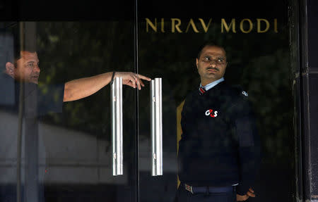 A security guard stands guard inside a Nirav Modi showroom during a raid by Enforcement Directorate, a government agency that fights financial crime, in New Delhi, India, February 15, 2018. REUTERS/Adnan Abidi