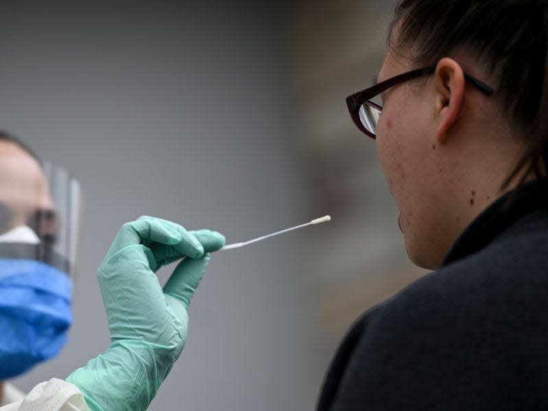 A medical assistant administers a COVID-19 test in Fridley, Minnesota.