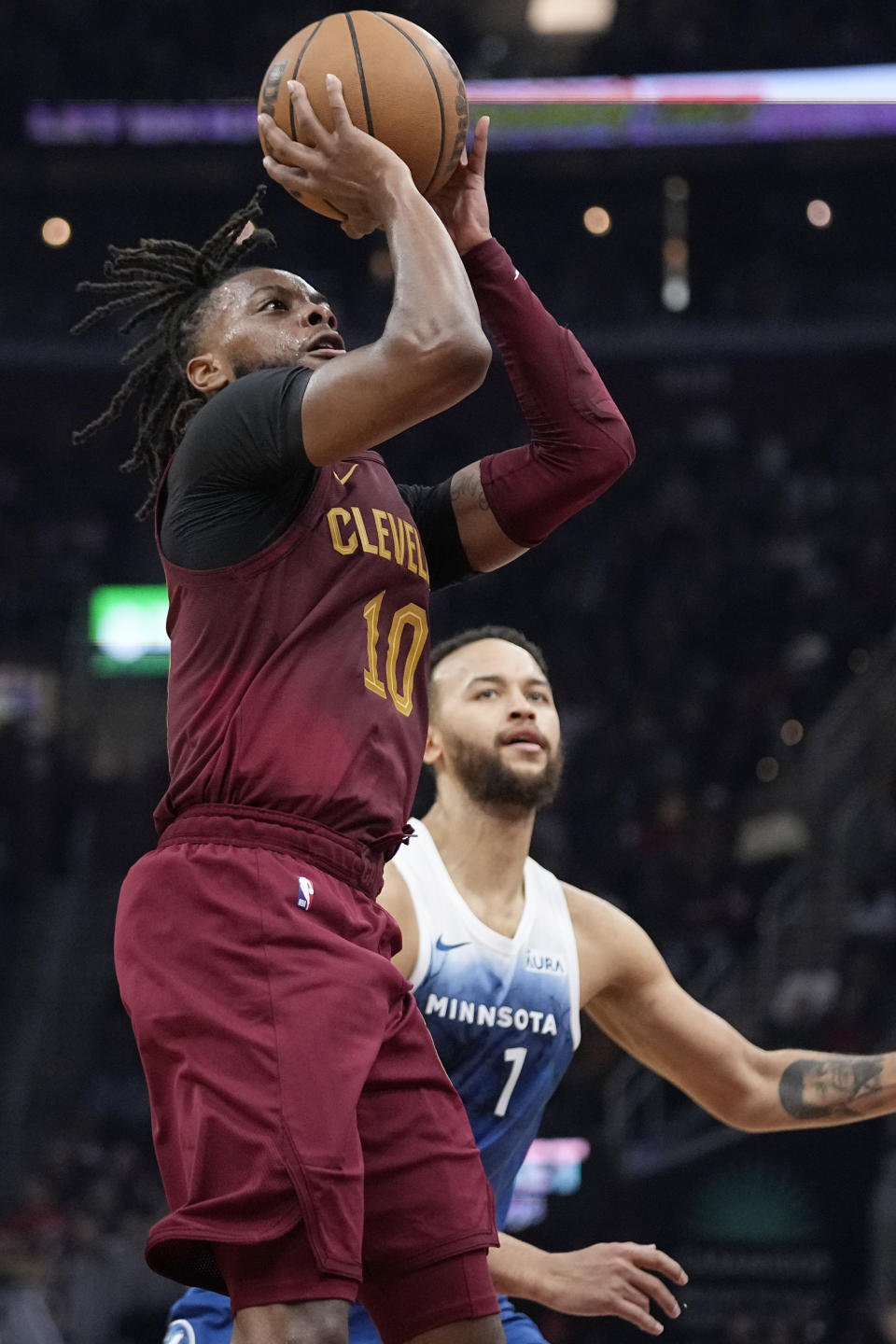 Cleveland Cavaliers guard Darius Garland (10) shoots next to Minnesota Timberwolves guard Wendell Moore Jr. (7) during the first half of an NBA basketball game Friday, March 8, 2024, in Cleveland. (AP Photo/Sue Ogrocki)