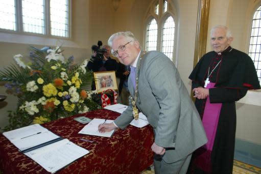 Bishop Patrick Walsh (right) – the detention giver – seen here signing a book of condolence for Pope John Paul II with Belfast Lord Mayor Tom Eakin (left)